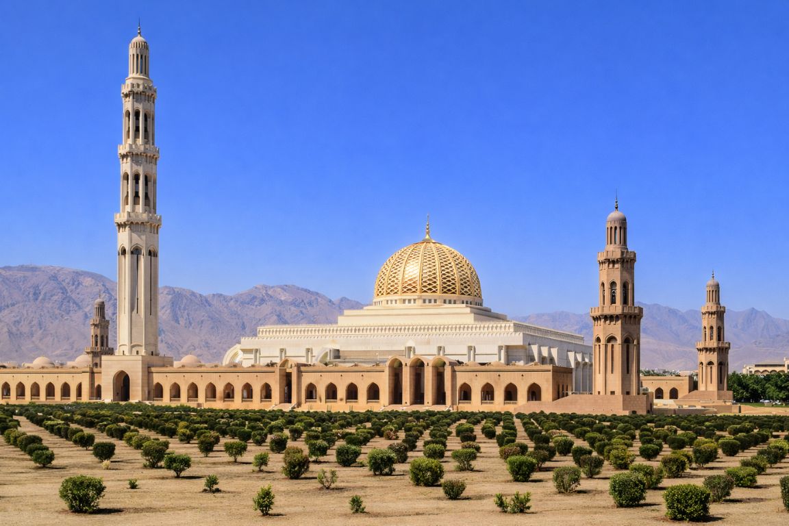 Sultan Qaboos Grand Mosque in Muscat with mountains in the background visited during a tour with Oman Muscat Tours